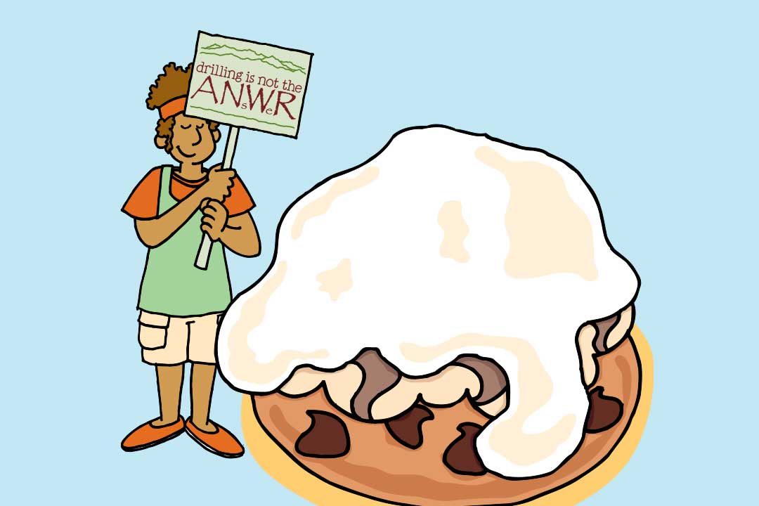 Una donna regge un cartello con scritto Drilling is Not the ANsWer accanto a un pezzo di Baked Alaska 